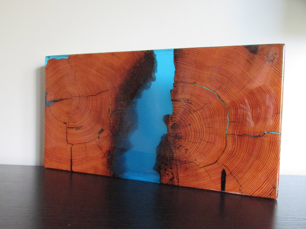 side table top made of red wood beam slices and blue epoxy resin pour